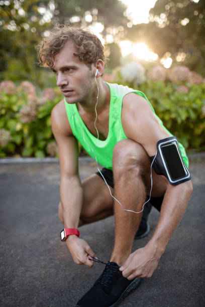 istock Man tying his shoe laces 649781166