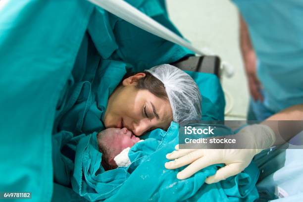 Young Mother Giving Birth To A Baby Stock Photo - Download Image Now - Childbirth, New Life, Hospital