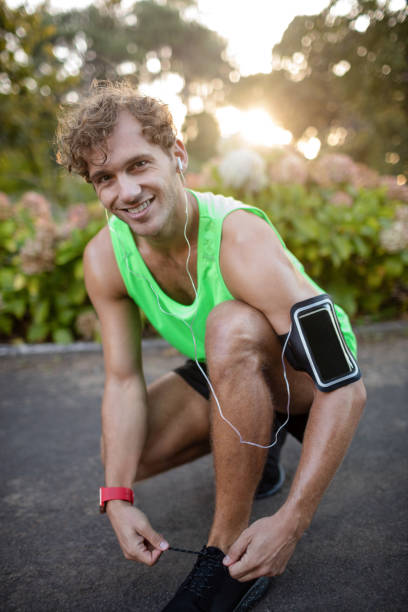 istock Smiling man tying his shoe laces 649782346