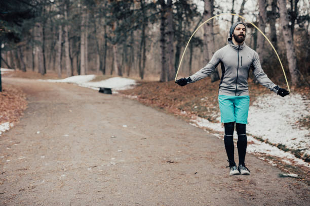 istock Handsome hipster skipping rope in the park 649787632