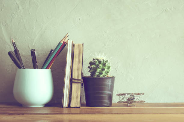 istock cactus flower with notebook on office wood table modern interior background concept. 649787792