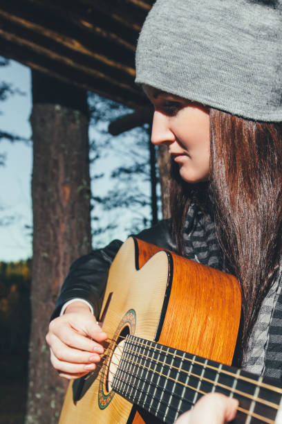 istock Girl Playing the Guitar 649788730