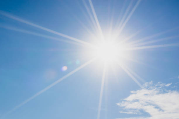 istock blue sky with clouds and sun reflection.The sun shines bright in the daytime in summer 649796066