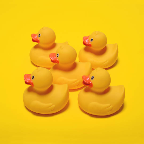 istock Yellow rubber ducks on yellow background - Minimal design 649796132