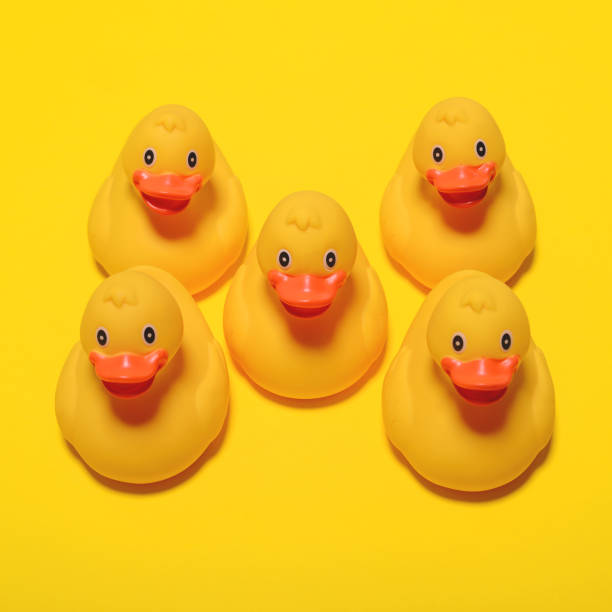 istock Yellow rubber ducks on yellow background - Minimal design 649796148