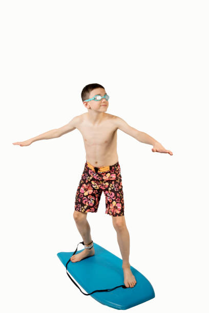 istock Teenage boy standing on a body board 649800392