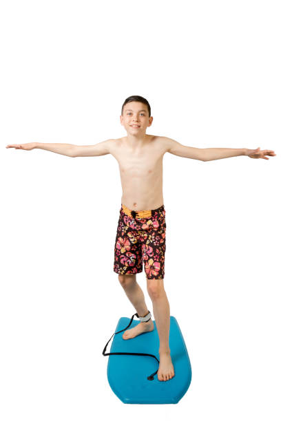 istock Teenage boy standing on a body board 649803688