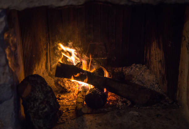 istock Traditional stone-made fireplace with burning wood 649813646