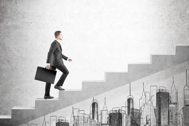 istock Blond man with suitcase climbing stairs 649814178