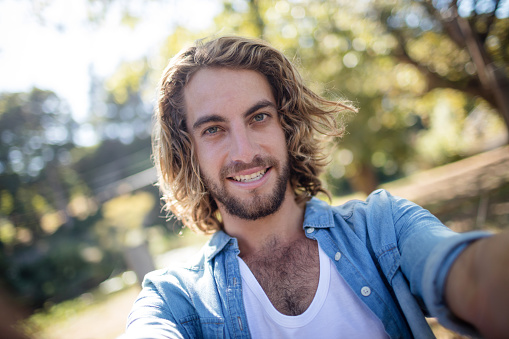 Portrait of smiling man standing in park