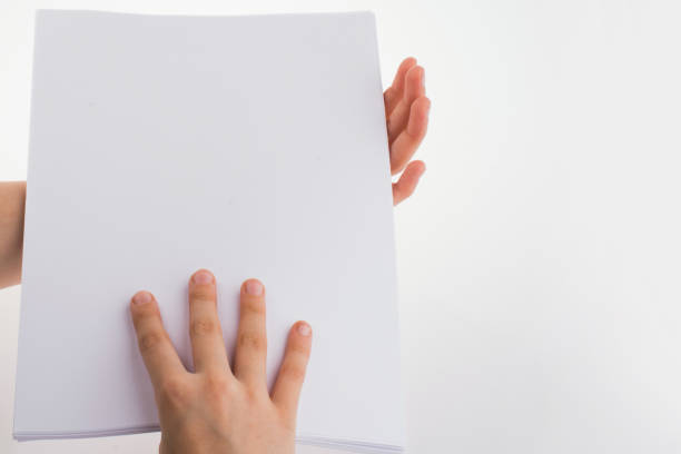 istock Hand holding a white blank sheet of paper 649825908