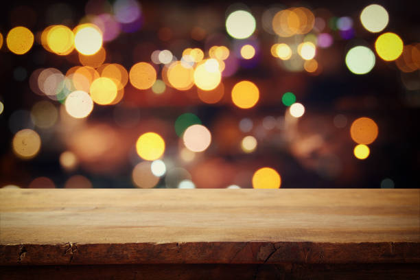 istock wooden table in front of abstract restaurant lights background 649825998