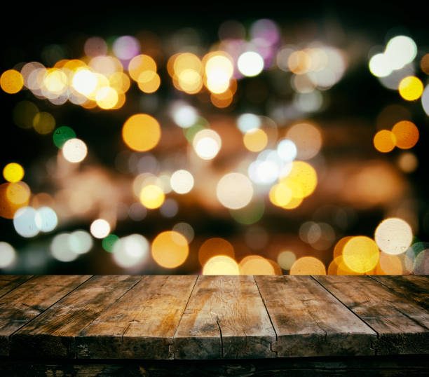 istock wooden table in front of abstract restaurant lights background 649826034