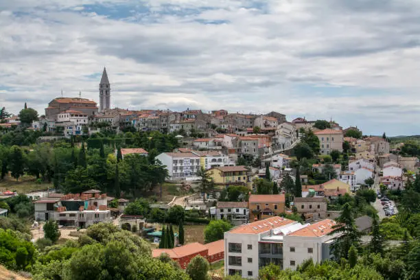 Panoramic view to old croatian town Vrsar. Ancient buildings and city tower on background.
