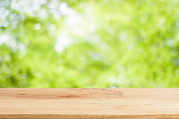 istock Wood table top on bokeh Green background 649829920