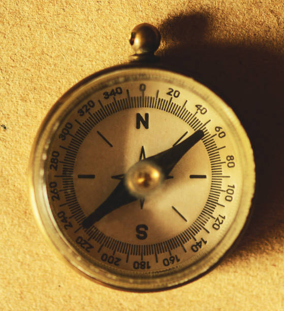 istock Close up view of the compass on old paper 649836528