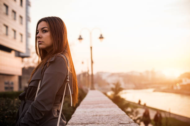 istock Sad woman standing near river 649840976