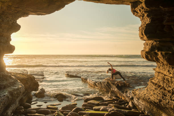 istock Ocean Cave Yoga In Golden Light 649852168