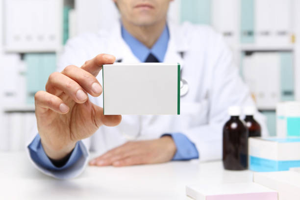 doctor hand showing drug boxes at office desktop. health care, medical and pharmacy concept. - pill box pill box medicine imagens e fotografias de stock