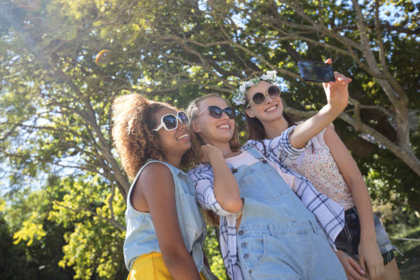 istock Female friends taking selfie with mobile phone 649859890