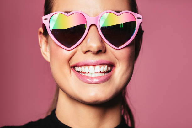 istock Young woman with heart shaped glasses 649859988