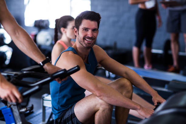 istock Happy young man exercising in gym 649863444