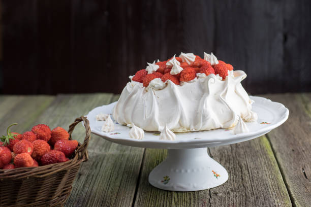 istock Strawberries Pavlova Cake on a White Plate with Strawberries in Wicker Basket 649863684