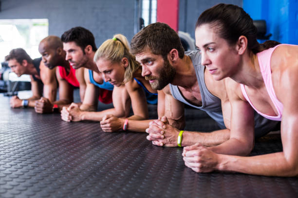 istock Serious friends exercising in gym 649864124
