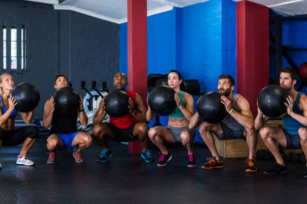 istock Friends holding exercise ball in gym 649864530