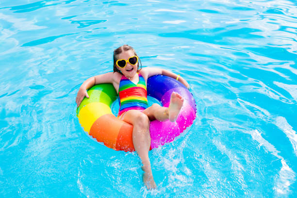 istock Child with toy ring in swimming pool 649875258