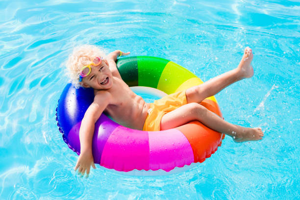 istock Child with toy ring in swimming pool 649875374