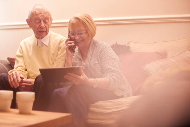 istock Senior couple on the phone and using digital tablet 649875858