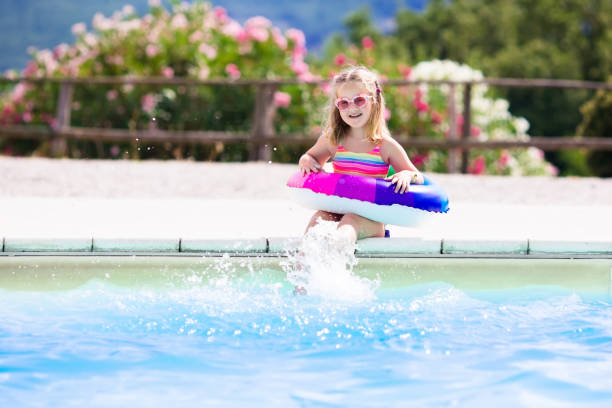 istock Child with toy ring in swimming pool 649878462