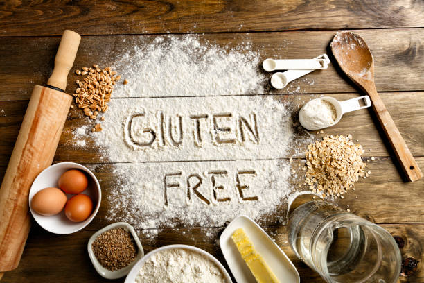istock Gluten free bread ingredients and utensils on wood frame background 649878614