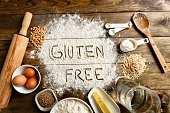 Gluten free bread ingredients and utensils on wood frame background