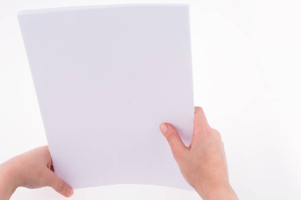 istock Hand holding a white blank sheet of paper 649881674