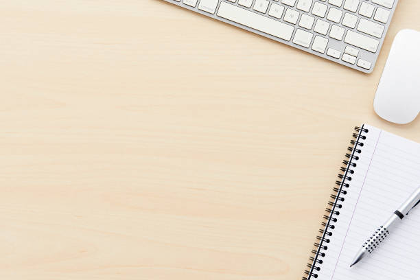 istock Keyboard, mouse, notepad and pen on light wooden desk with copy space 649882470
