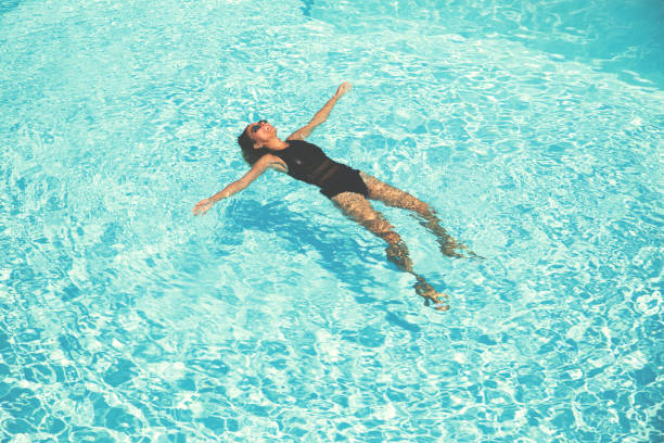 istock Woman Floating in a swimming pool 649882644