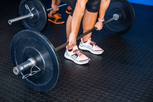 istock People lifting barbell at gym 649886462