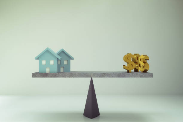 dollar sign and house on balance board