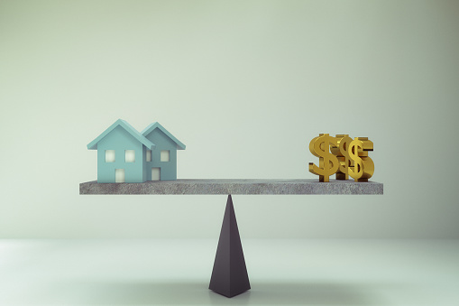 3D rendering of dollar sign with house on balance board