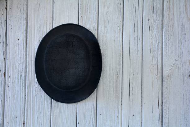 istock Of old black man's hat hangs on wooden wall 649893964