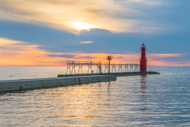 istock Lake Michigan Sunrise with iconic pier and Lighthouse. 649894122