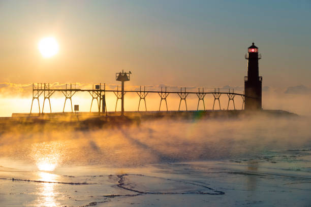istock Cold steaming Lake Michigan at Sunrise with iconic Lighthouse 649894222