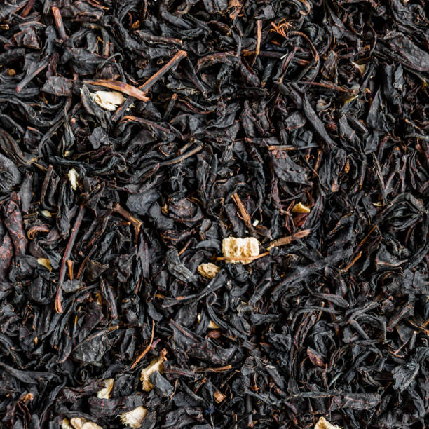 istock Black tea background. Heap of dry black tea 649894224