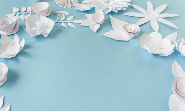 istock frame with white paper flowers on blue background. Cut from paper. 649898078