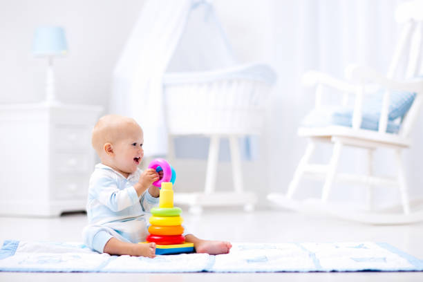 istock Baby playing with toy pyramid. Kids play 649900752