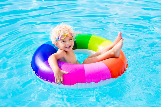 istock Child with toy ring in swimming pool 649900872