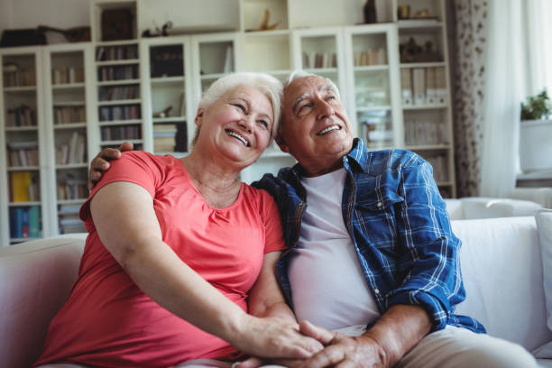 istock Senior couple sitting together on sofa 649902166