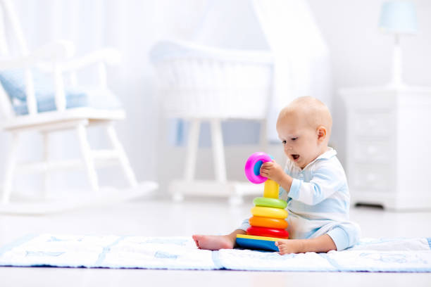 istock Baby playing with toy pyramid. Kids play 649902388